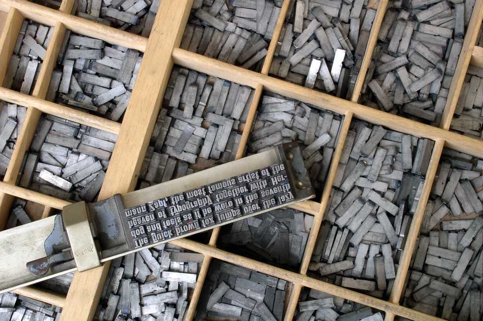 Movable metal type, and composing stick, descended from Gutenberg's press. Photo by Willi Heidelbach. Licensed under CC BY 2.5